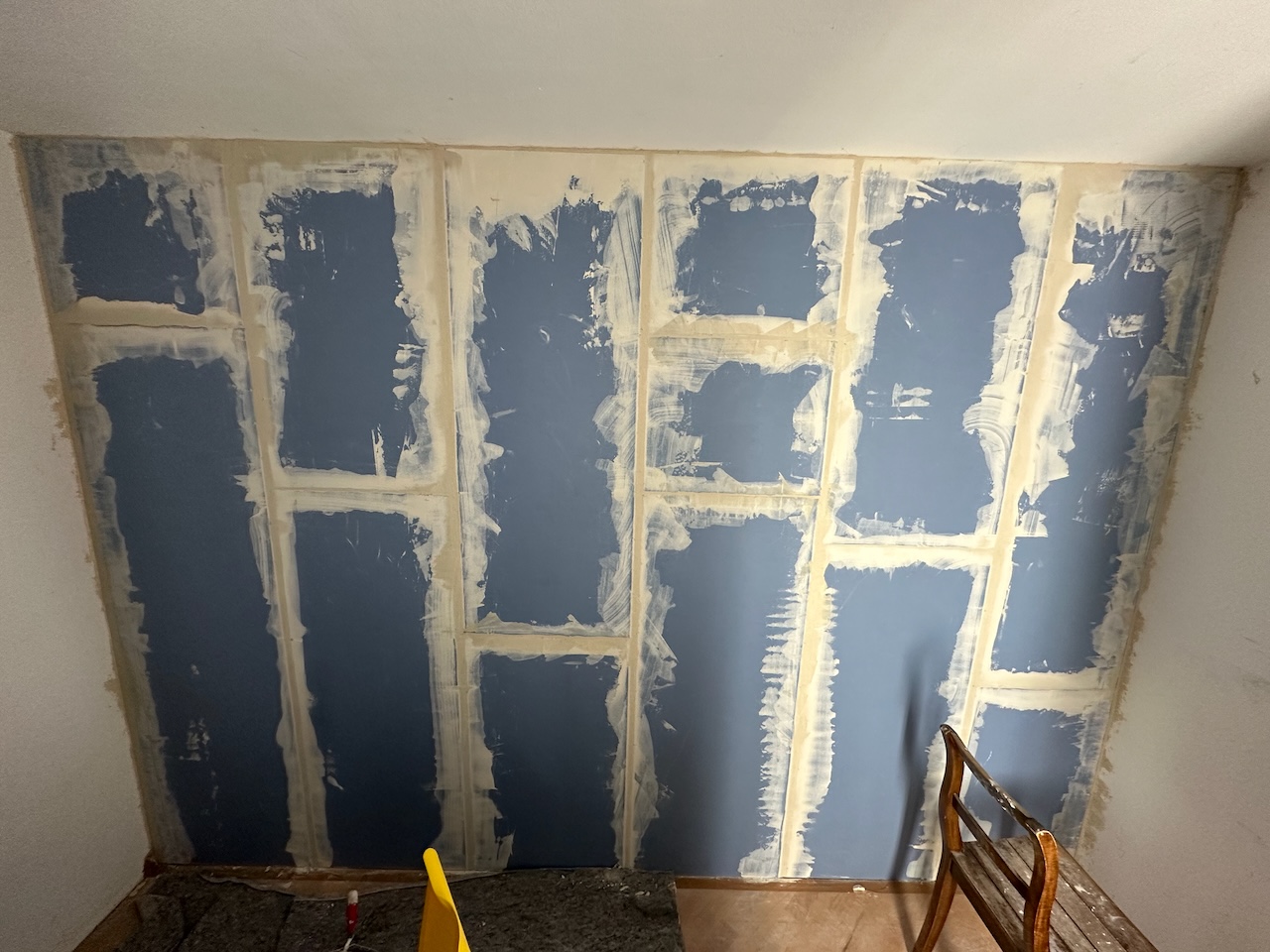 The next morning I applied the mudding. Pretty obvious here that this was my first time. It looks fairly chaotic, but honestly, it’s smoother than I thought it was going to be. Not that it matters, really, there will be an impact screen in front of this wall anyway.